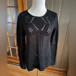 Black knitted top, with side slits.